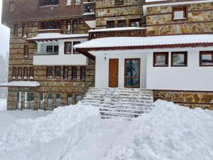 a pile of snow in front of a house at La'Vista in Smolyan