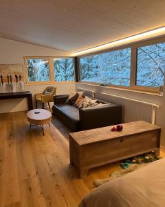 a living room with a couch and a table at River Lodge in Dornbirn