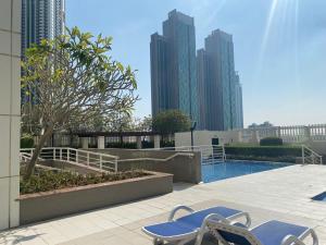 a pool in a city with tall buildings at Sea View Cozy 2BHK Al Reem 6ppl - more than 10 days stay free transportation from Abu Dhabi Airport- in Abu Dhabi