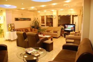a large living room with couches and a television at Topkapı Otel Özyavuz in Istanbul
