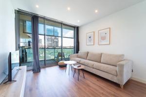 a living room with a couch and a table at Unique Rentals-Seafront Luxe Suites in Barcelona