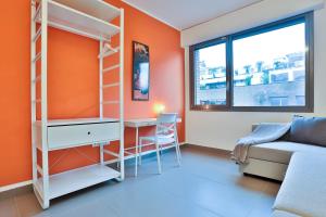 a room with a bed and a desk and a couch at Sebeto Apartments with Parking & Netflix in Naples