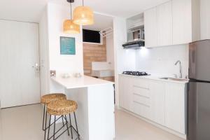 Virtuvė arba virtuvėlė apgyvendinimo įstaigoje Origen Local Suites