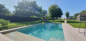 a swimming pool in the backyard of a house at WanT Logies: Ruime loft in Damme