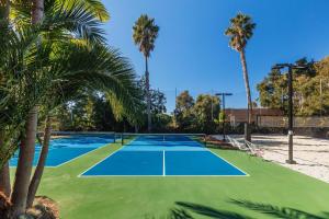 a tennis court with palm trees in the background at ENC-1408 - Enchanting Encinitas Retreat in Encinitas