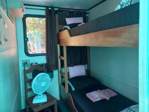 a bedroom with two bunk beds and a window at Barco Casa Pantanal Toca da Onça in Poconé