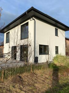 a white house with a fence in front of it at Anwesen mit Charme in Koblach