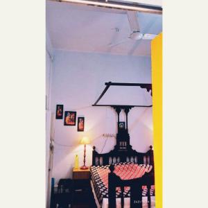 a dining room with a table and a lamp at Happy Home in Kolkata