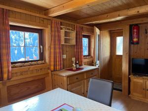 a kitchen with a table and a television in a cabin at Mühle in Görtschach in Sankt Veit in Defereggen