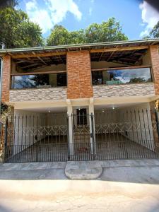 an iron fence in front of a house at Chalés de Santana in Tiradentes +10 photos