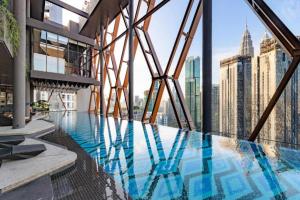 a swimming pool on top of a building with a view at Scarletz Suites KLCC Twin Tower by Purple Orchid in Kuala Lumpur