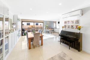a living room with a piano and a table at Chateau Gabriel Luxury 6 BR Villa with Heated Pool in Bet Shemesh