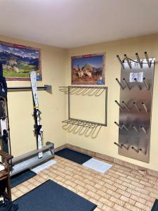 a room with a gym with ski equipment on the wall at Haus Gröblacher in Mayrhofen