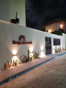 a white building with lights on the side of it at Zaya Beach Residence in Icaraí