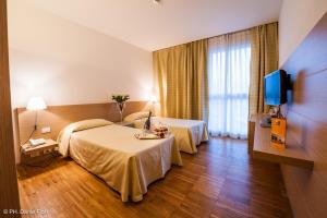 a hotel room with two beds and a television at Schio Hotel in Schio +39 photos