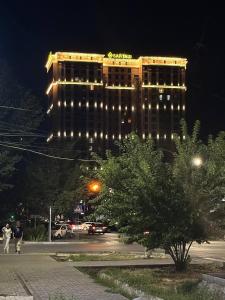 Um edifício iluminado com um sinal do Pai Natal. em Designer apartment near the Gum shopping center em Bishkek