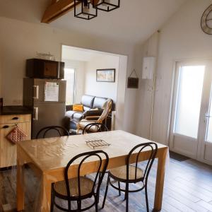 a kitchen and living room with a table and chairs at Le Bas Champ in Favières +14 photos