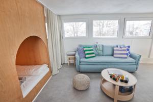 a living room with a couch and a table at Unique Boat Apartments by Lake - Kajuta 1958 in Námestovo