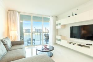 a living room with a couch and a tv at Marina Bay 113 in Miami Beach