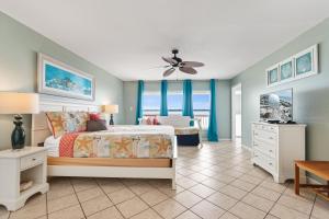 ein Schlafzimmer mit einem Bett mit blauen Wänden und einem Deckenventilator in der Unterkunft Breezeway in Navarre