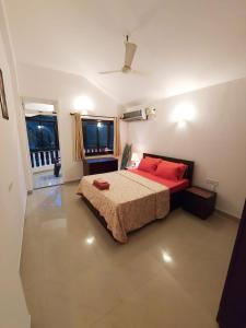 a bedroom with a large bed with red pillows at Casale Majorda in Majorda