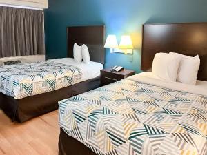 a hotel room with two beds in a room at Studio 6 Suites Shreveport, LA Industrial Loop in Shreveport