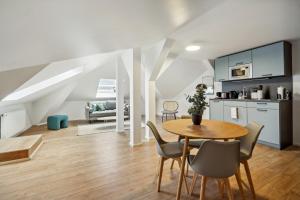 a kitchen and dining room with a table and chairs at limehome Dresden Antonstraße in Dresden
