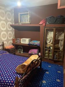 a bedroom with a bed and a bunk bed with a microwave at Grand Atlas Guesthouse 44 km from Marrakech in Marrakech
