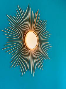 a gold mandala with rays on a blue background at Al Campanile in Nicolosi