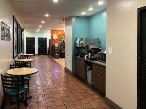 a restaurant with tables and chairs in a room at Motel 6 Mesquite, TX Town East in Mesquite