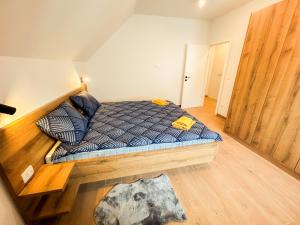 a small bed in a room with a wooden floor at Villa verde leisure apartment in Tarvisio +28 photos