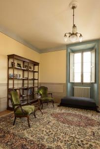 a living room filled with furniture and a window at B&B Palazzo Mattei in Novafeltria