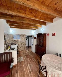 a kitchen and a living room with wooden ceilings at Gobernador Roca Duplex in Gobernador Roca