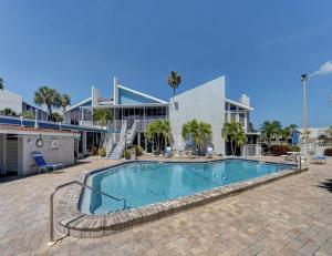 a swimming pool in front of a building at Madeira Beach Yacht Club 247f in St. Pete Beach