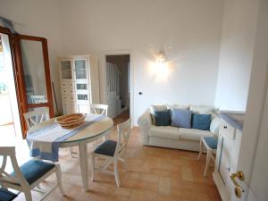 a living room with a table and a couch at Villaggio Di Mezzo Ortano in Rio Marina
