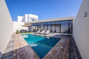a swimming pool in the backyard of a house at AYA Boutique - Oasis in Al Muntazah 3BR Villa with Private Pool in Abu Dhabi