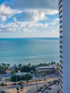 a view of the ocean from a building at Ilusion Flat Ponta Negra in Natal