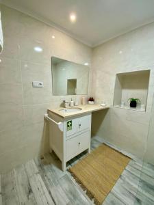 a bathroom with a sink and a mirror at CASA do AÇÔR in Aldeia das Dez