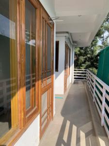 a hallway of a house with a door and a porch at Modern Comforts with a view in Dehradun