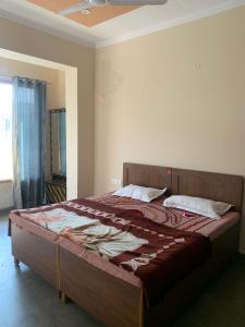 a bedroom with a large bed in a room at Modern Comforts with a view in Dehradun