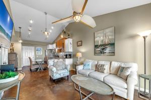 a living room with a couch and a table at Baywatch Unit H5 in Pensacola Beach