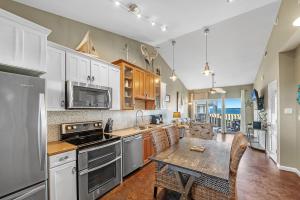 a kitchen with a table and a dining room at Baywatch Unit H5 in Pensacola Beach