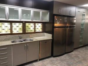 eine Küche mit einer Spüle und einem Kühlschrank in der Unterkunft Casa na Serra incrivel com vista para as montanhas in Petrópolis