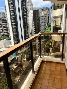 a balcony with a view of a city at Flat Manhattan Residence Service in São Paulo