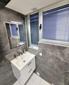 a bathroom with a sink and a mirror at Motel Gas-Petrol in Brčko