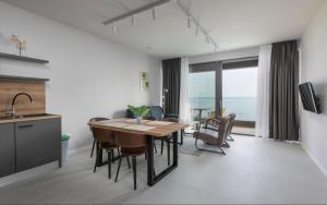 a kitchen and dining room with a table and chairs at DINORA Exclusive Apartments in Makarska