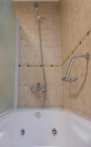 a shower with a shower head in a bathroom at Del Sur Apart in Esquel