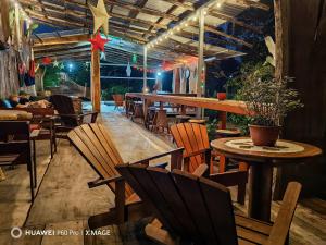 a restaurant with tables and chairs and a star on the ceiling at Arenal Xilopalo in Fortuna
