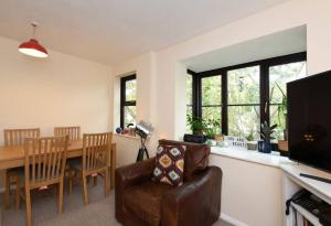 倫敦的住宿－Spacious Walthamstow Apartment，客厅配有桌子、沙发和椅子