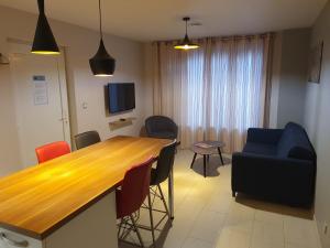 a living room with a wooden table and chairs at Gites Du Ladhof in Colmar